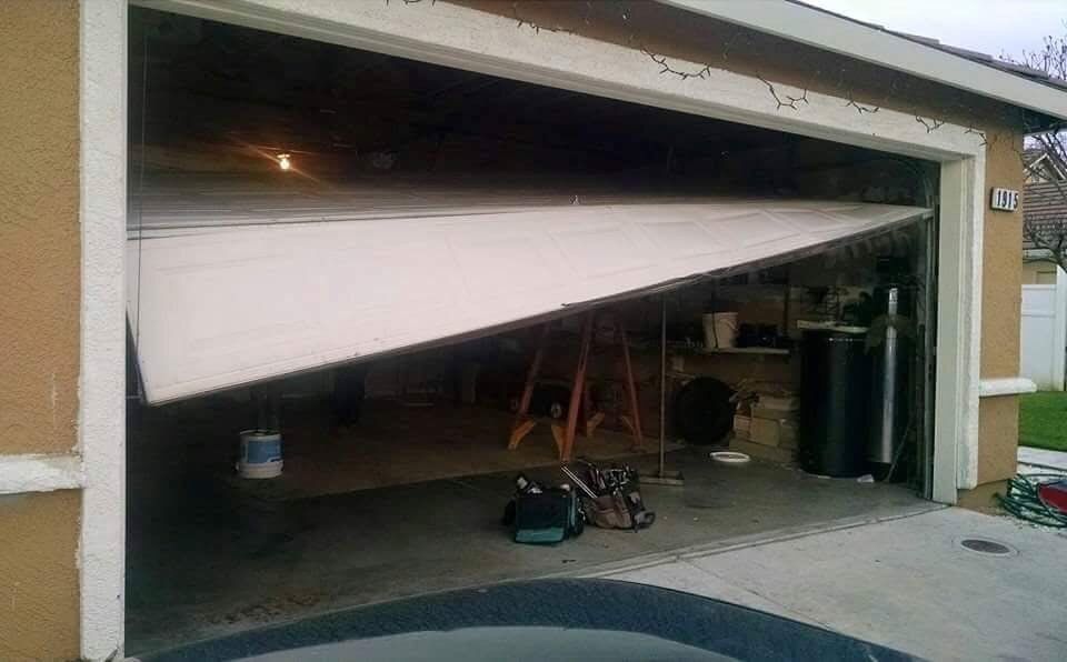 A garage door is open and broken in half.