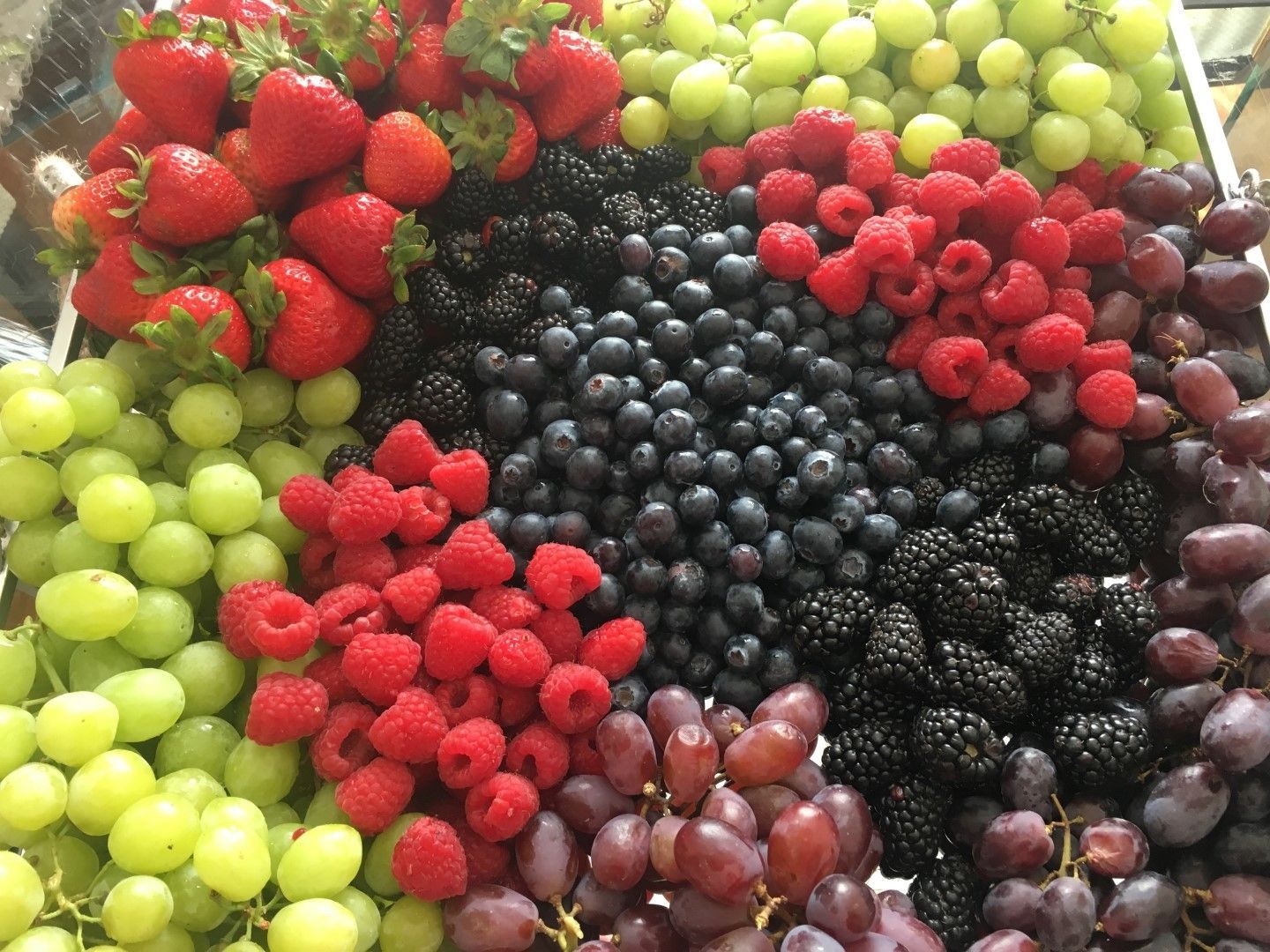 A variety of berries including strawberries , raspberries , blueberries , blackberries and grapes