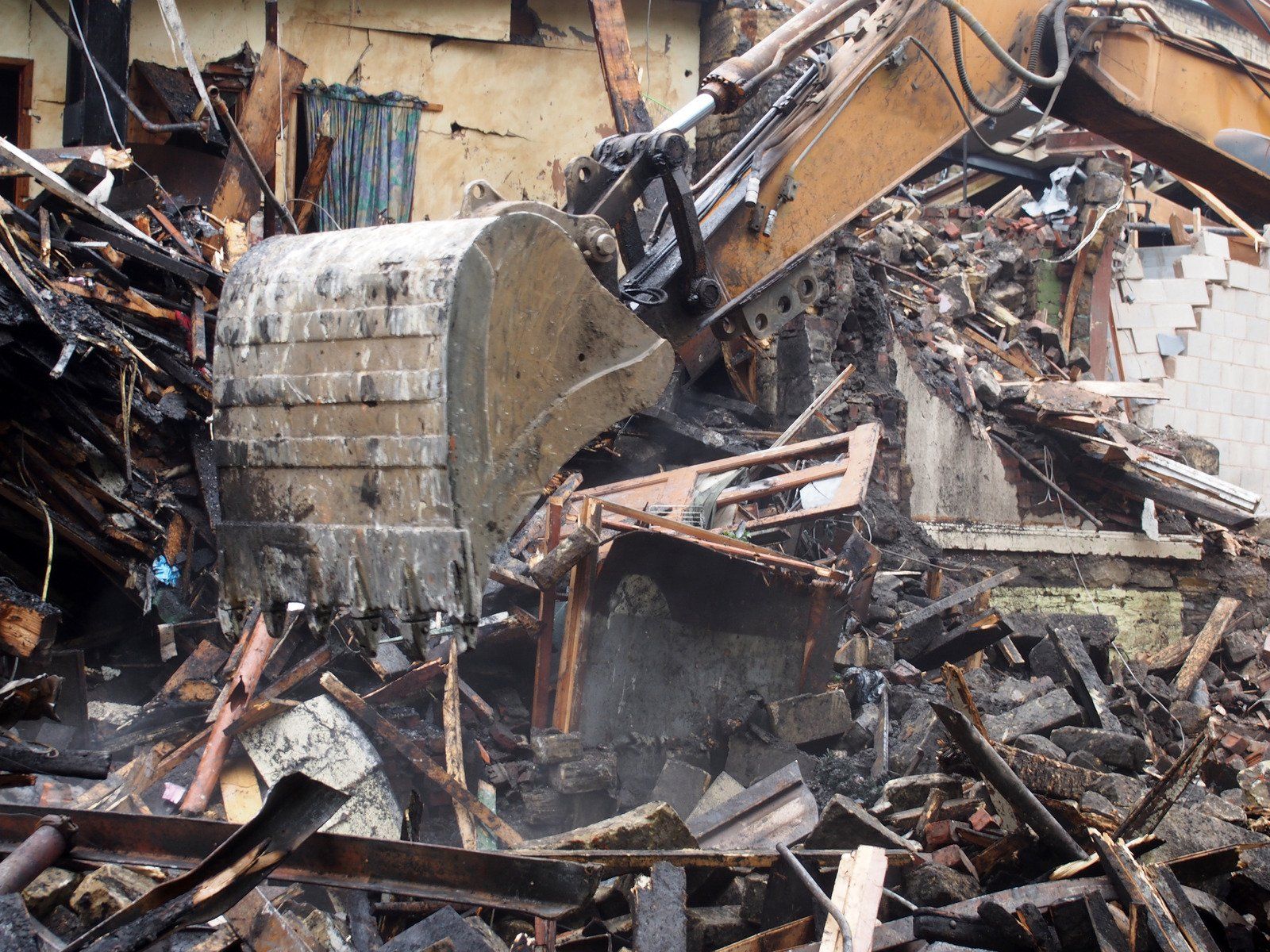 Excavator claw clearing debris