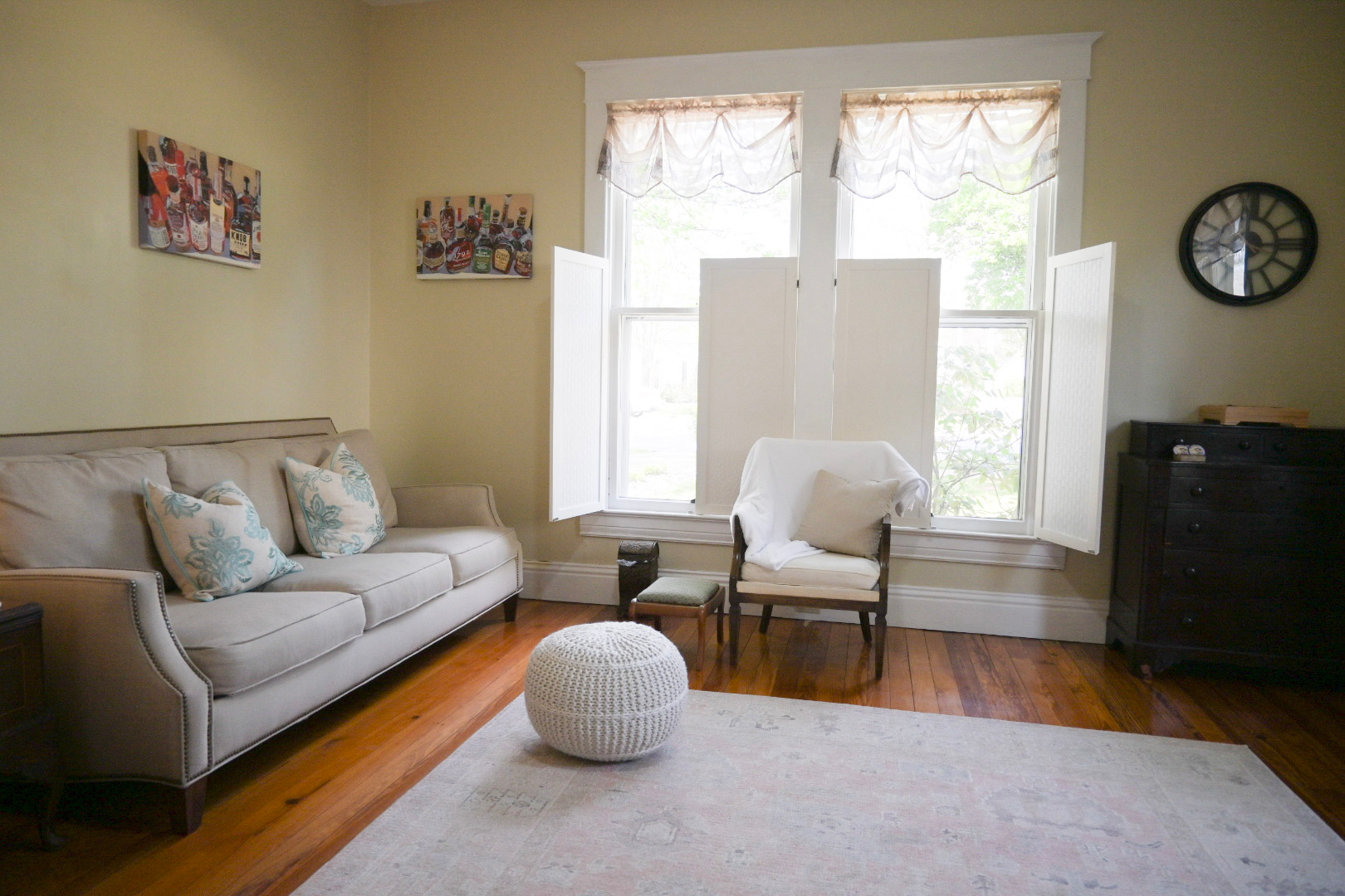A living room with yellow walls and a fireplace