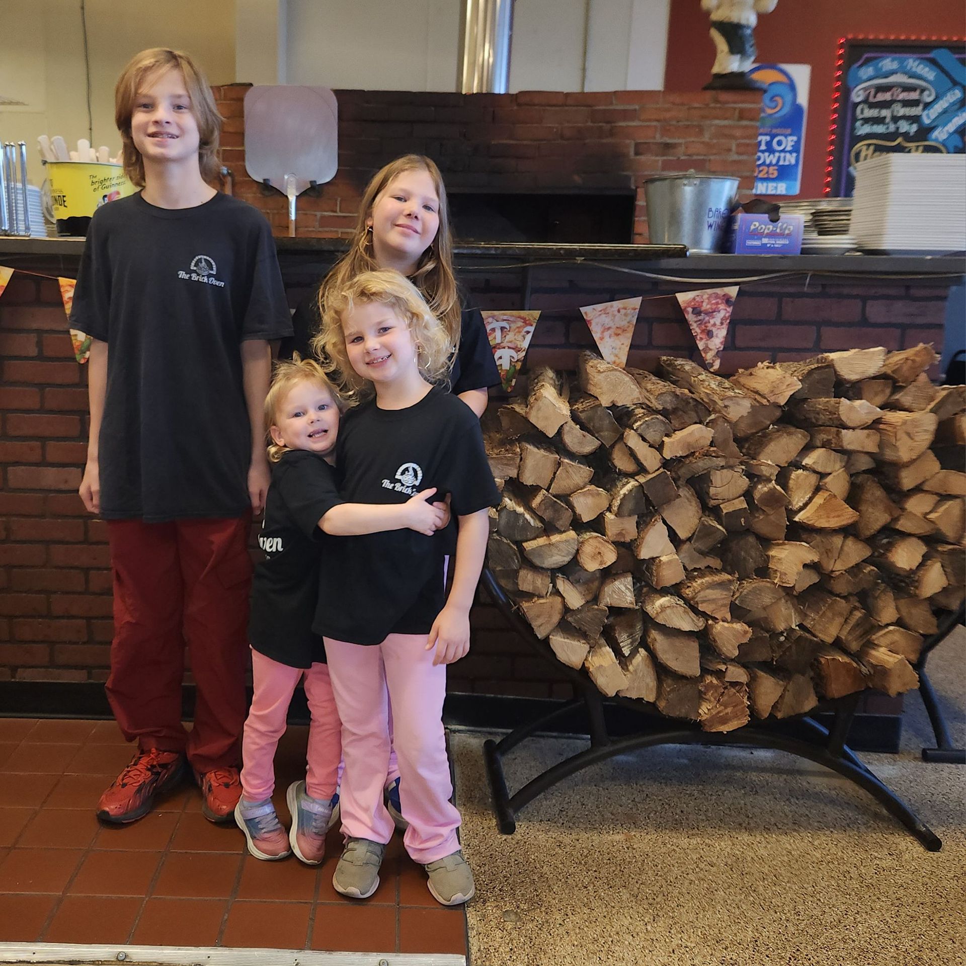 Boy Holding Bakers Paddle Pizza — Delicious Italian Pizza in Foley, AL