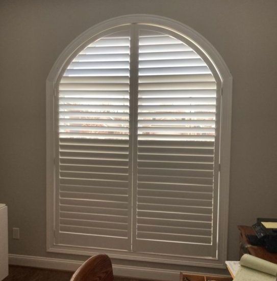 Arched Windows Lexington, KY A room with a large arched window with white shutters