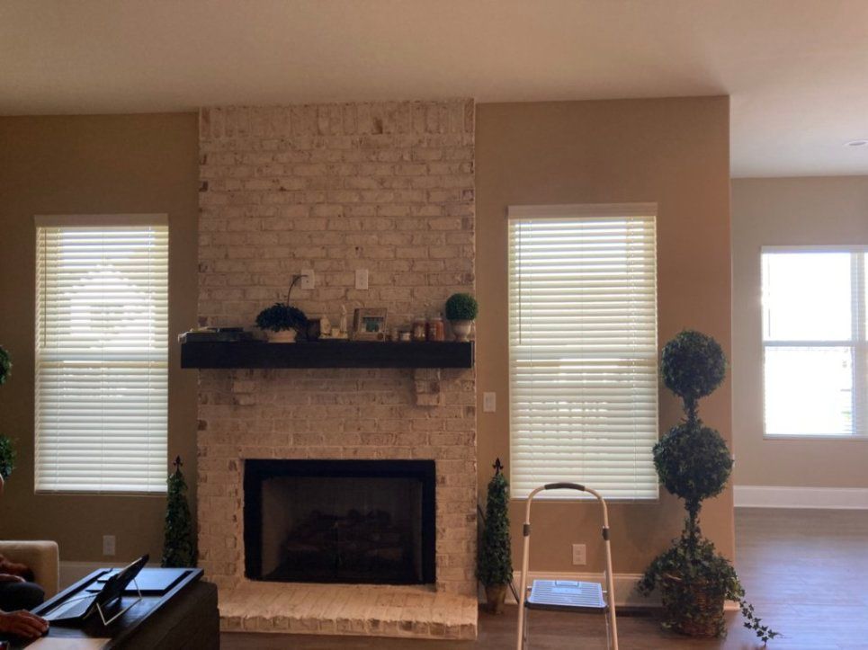There is a fireplace in the middle of the living room.