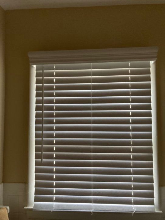 A window with blinds on it in a room