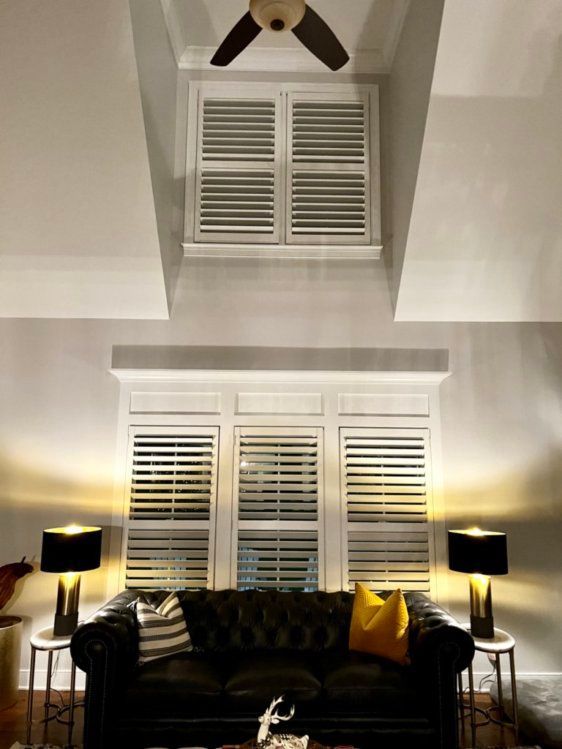 A living room with a couch and a ceiling fan