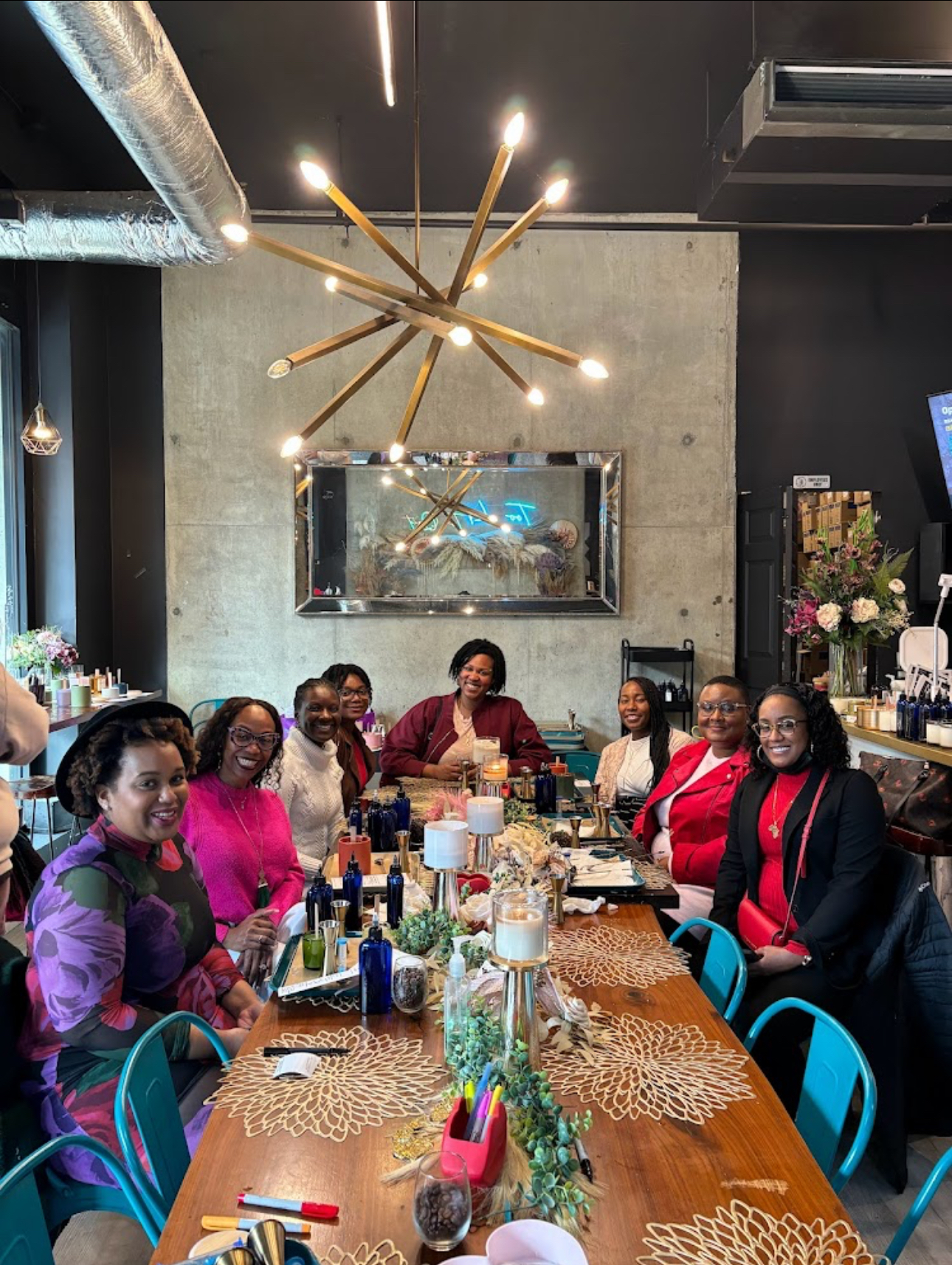 A group of women are sitting around a long table