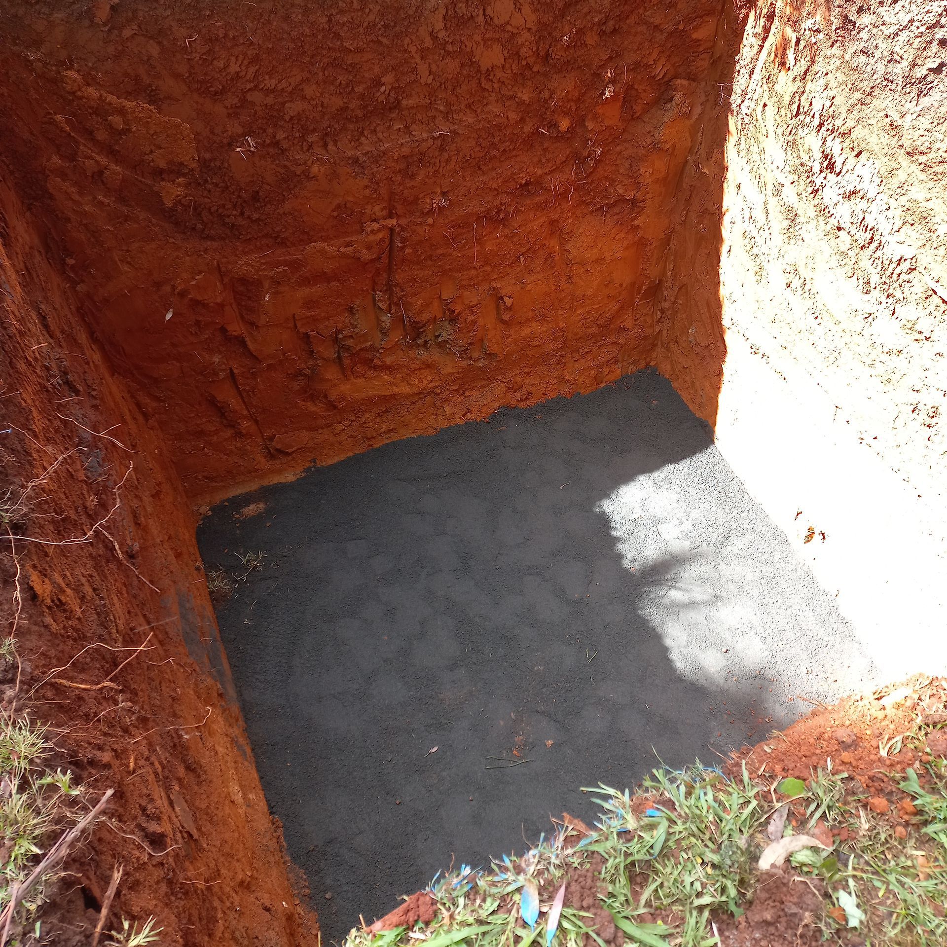 A Hole in the Ground With a Black Mat in It — Bevan Plumbing in South Lismore, NSW
