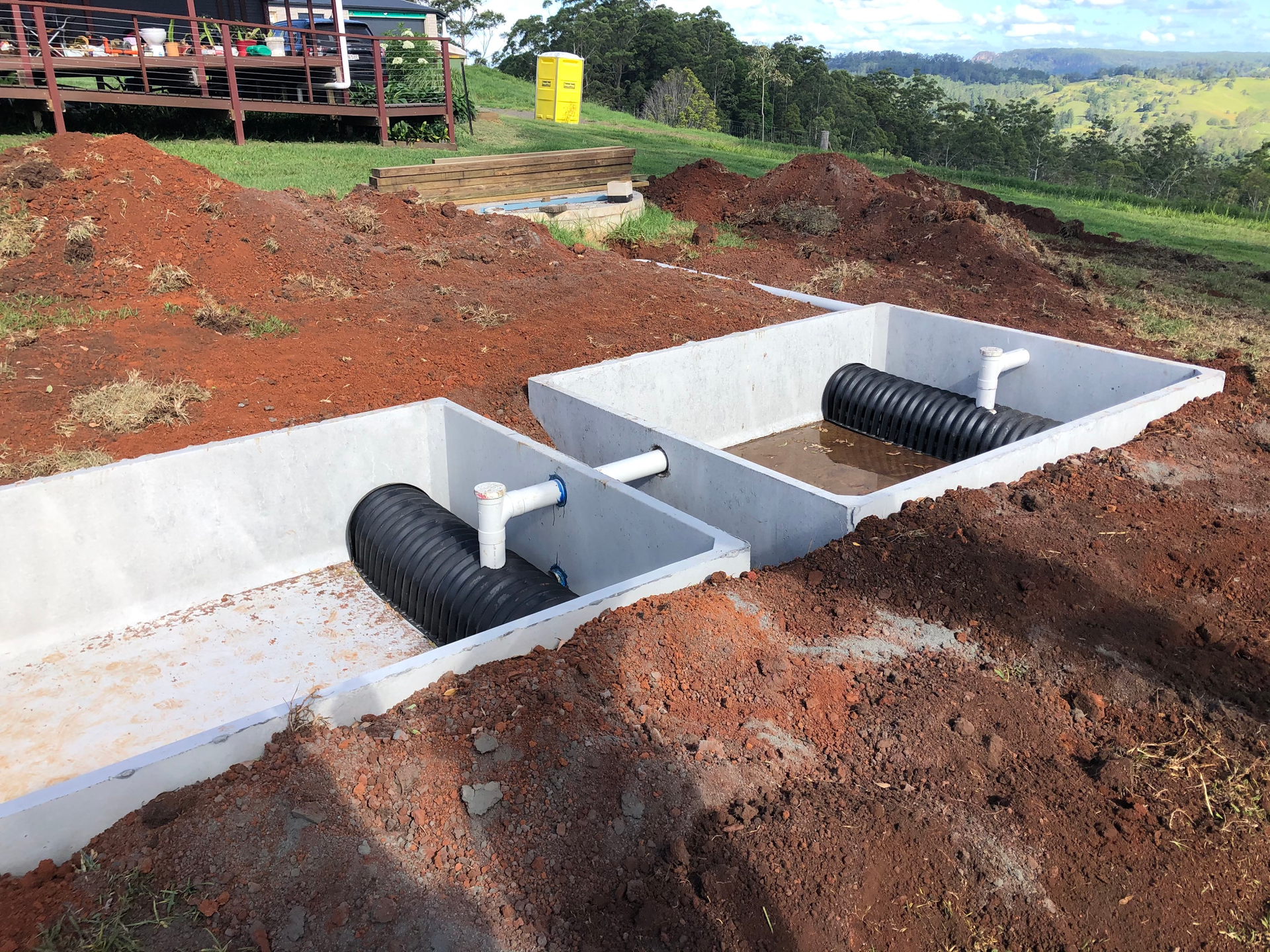 A Couple of Concrete Boxes Sitting on Top of a Pile of Dirt — Bevan Plumbing in Ballina, NSW
