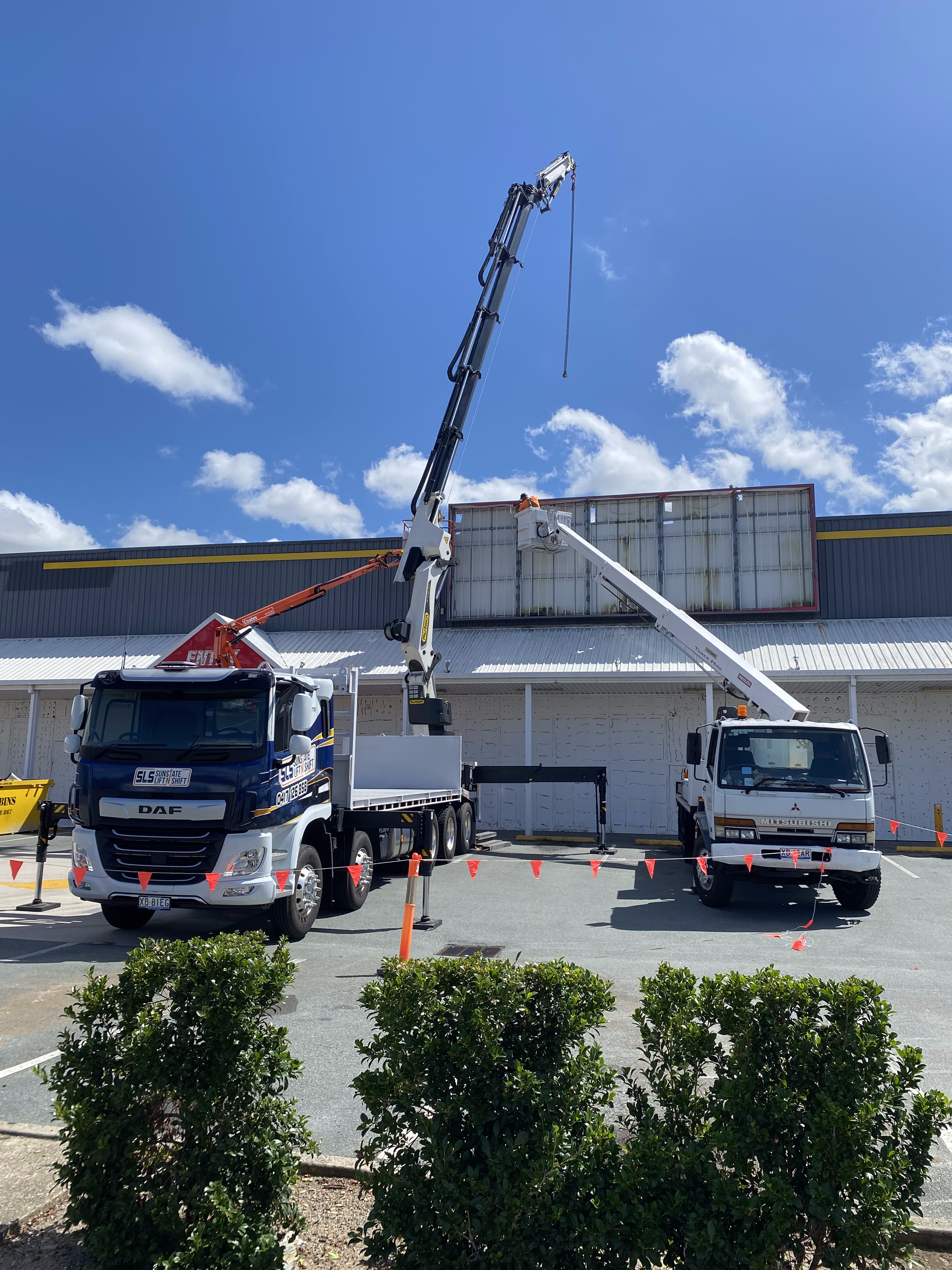 Lifting Of A Big White Bin With Visible Of A Crane's Boom And Its Hook — Supply Lifting Equipment in Cooroibah, QLD