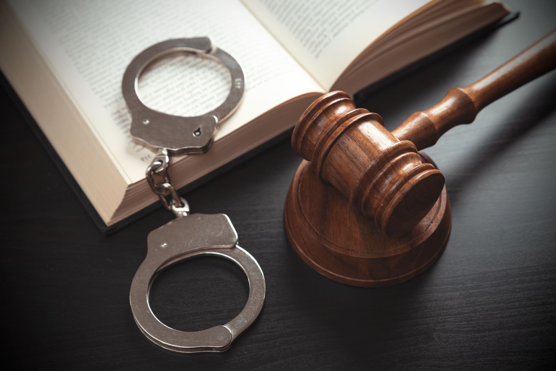 Handcuffs, gavel, and book.