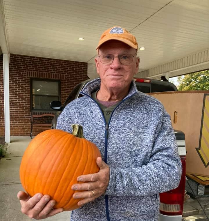 Image of man holding pumpkin