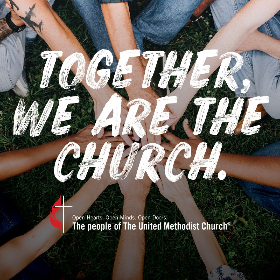 A group of people putting their hands together with the words together we are the church