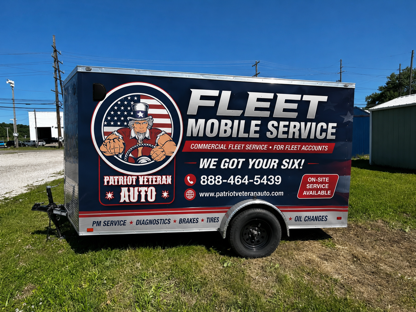 Fleet Mobile Service trailer with tire graphics parked outdoors on a sunny roadside.