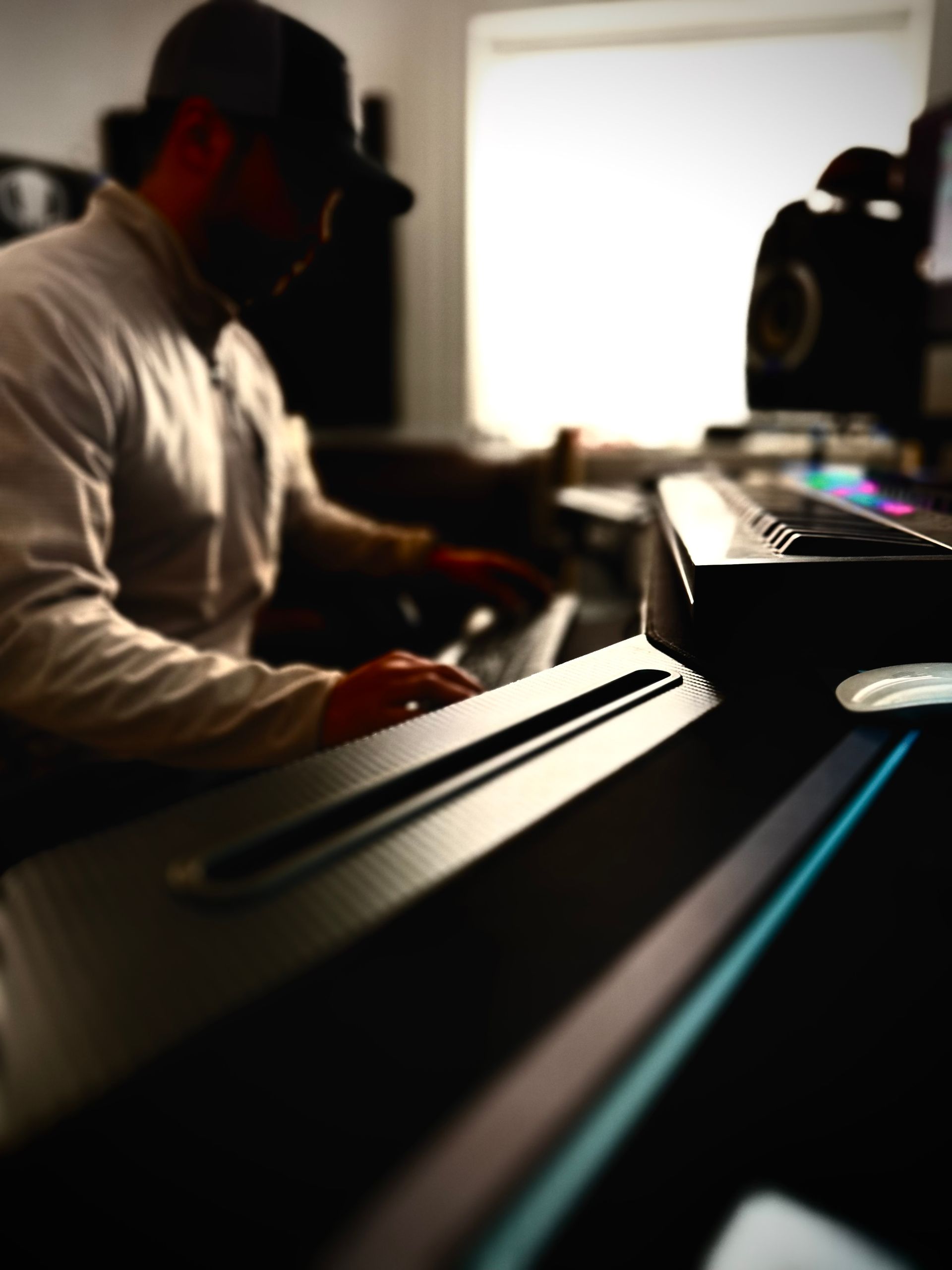 A man is playing a keyboard in a dark room