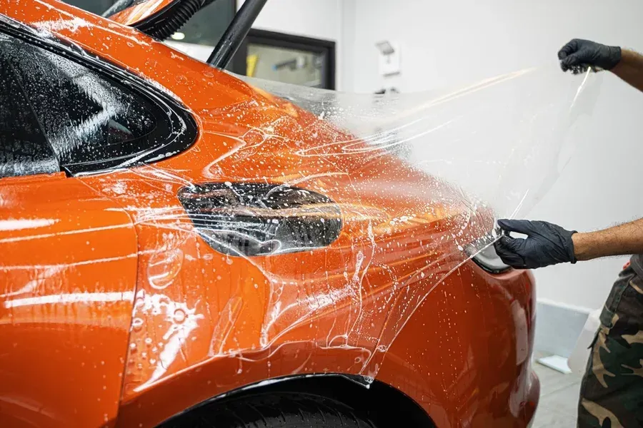 A paint protection film being expertly applied.