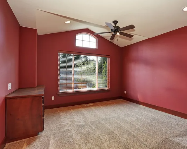 Empty Room With Red Walls and Ceiling Fan — MDSR Group In Manunda, QLD