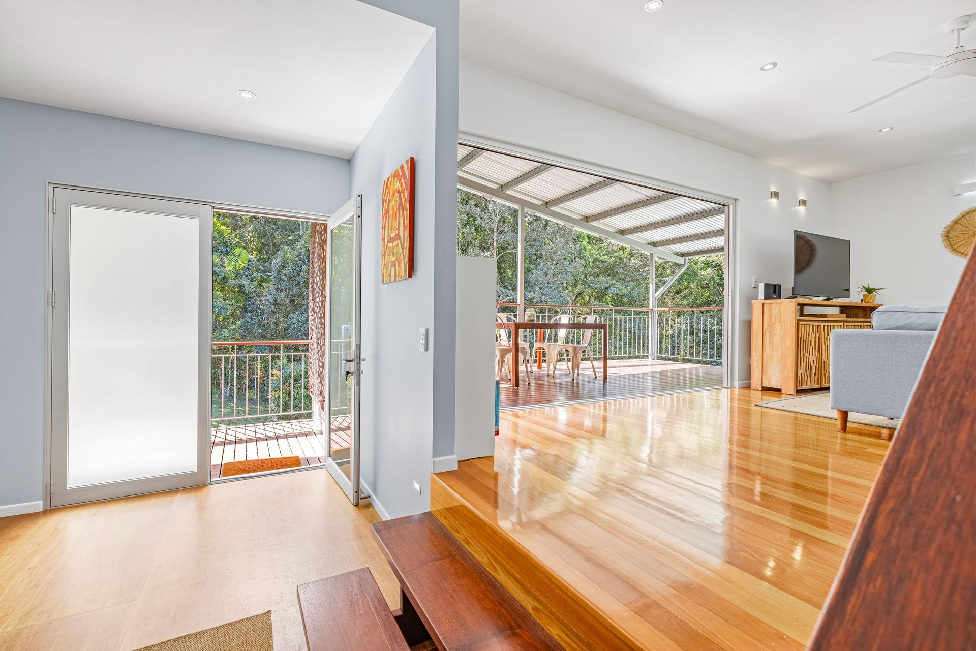 Open Living Space With a Balcony, Patio, and Hardwood Floors — MDSR Group In Manunda, QLD