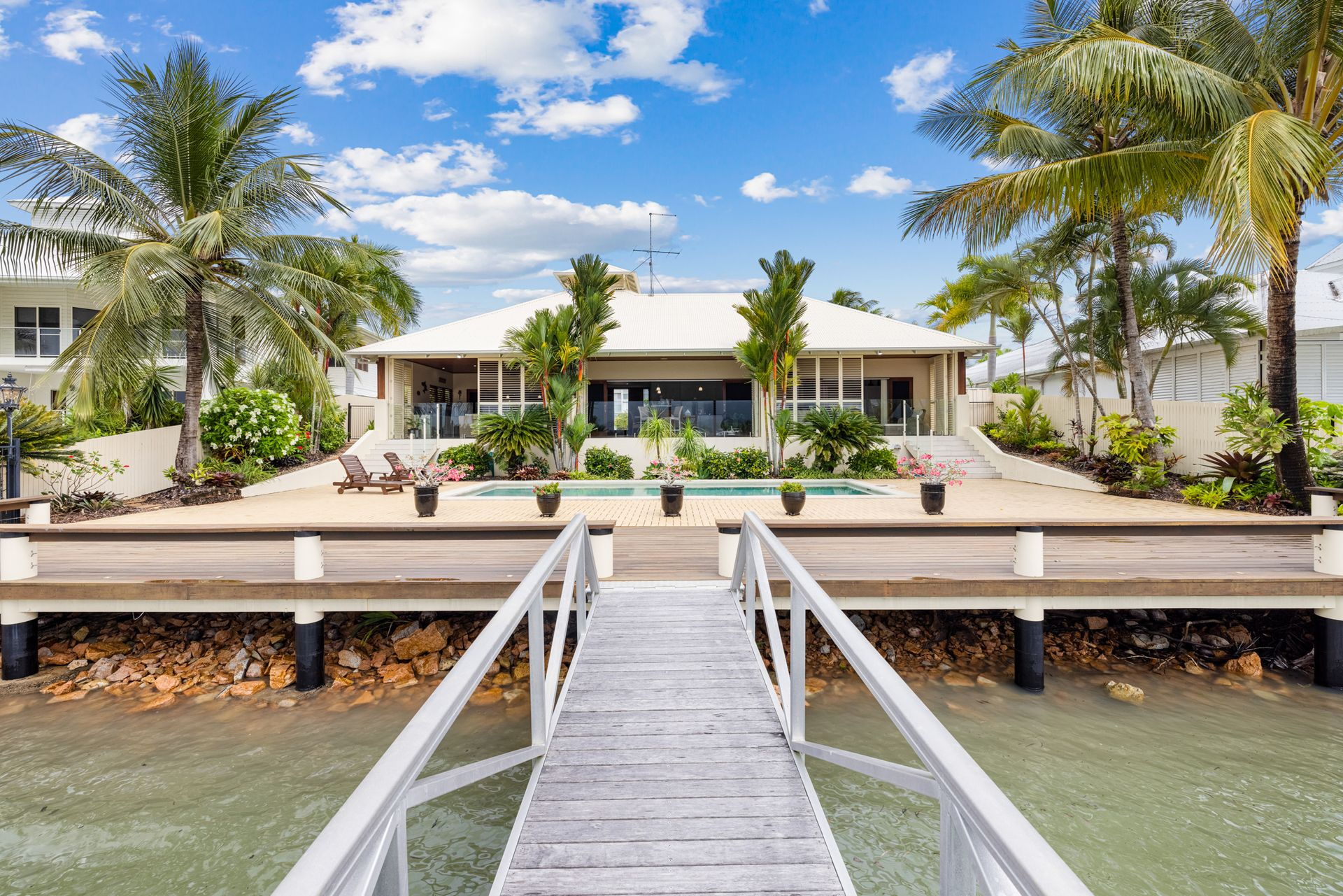Waterfront Home With Pool, Dock, and Palm Trees — MDSR Group In Manunda, QLD