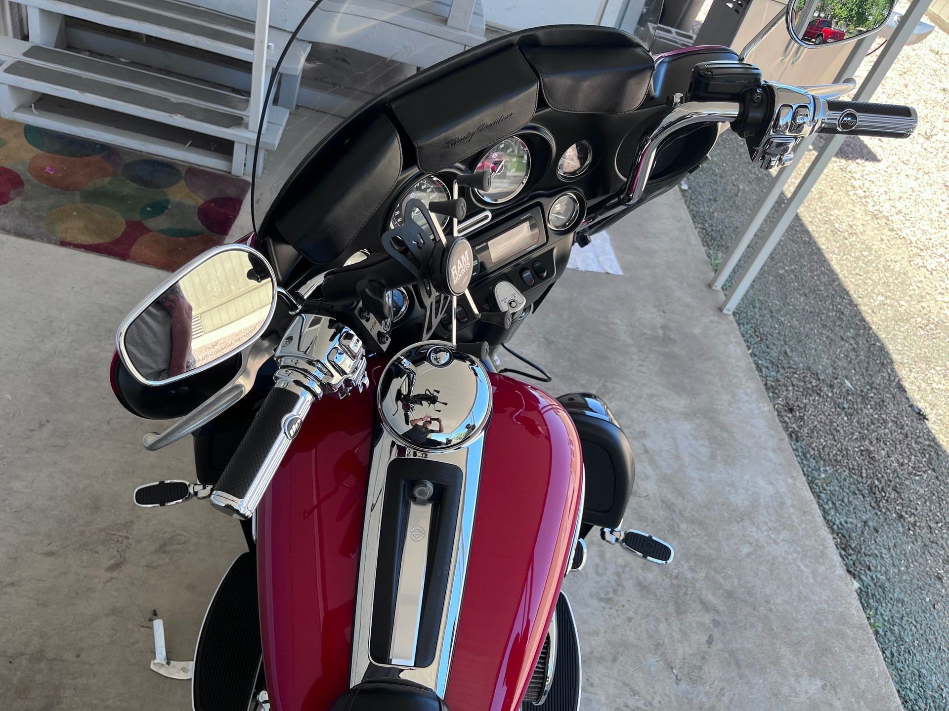 A red harley davidson motorcycle is parked in a garage.