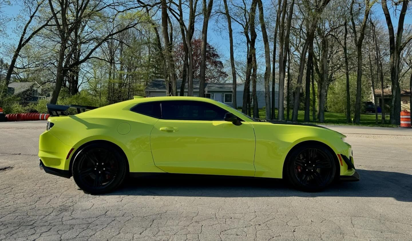 Bright green sports car with dark window tint parked in Elm Grove WI