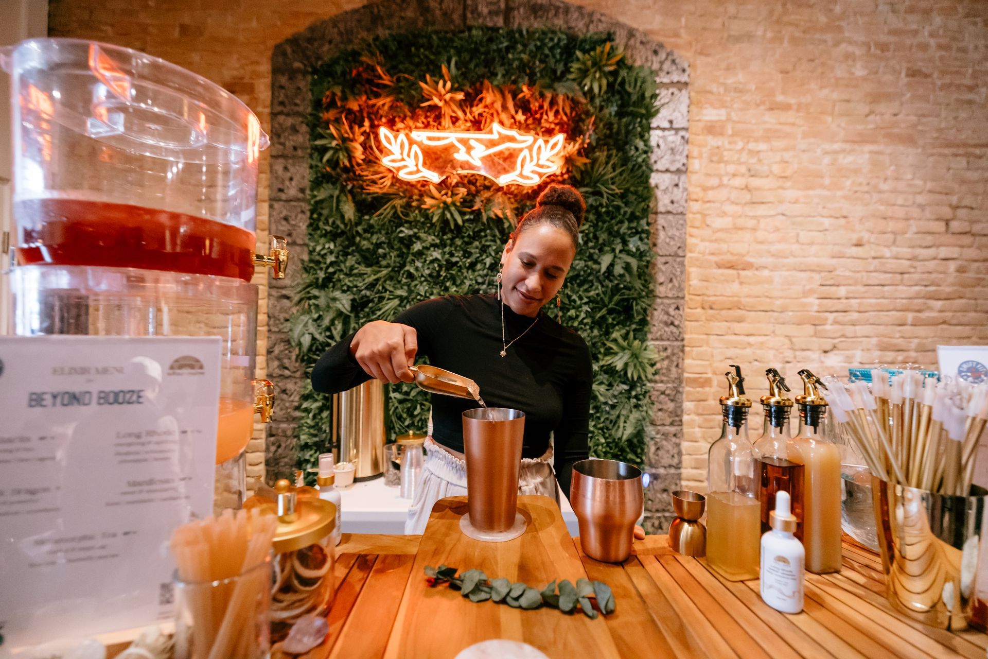 Altar Native Founder Yasmin making a functional elixir behind the bar