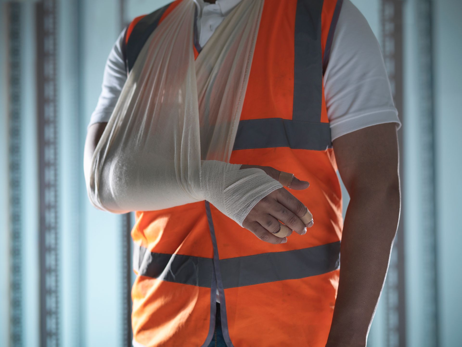 A construction worker with a cast on his arm.