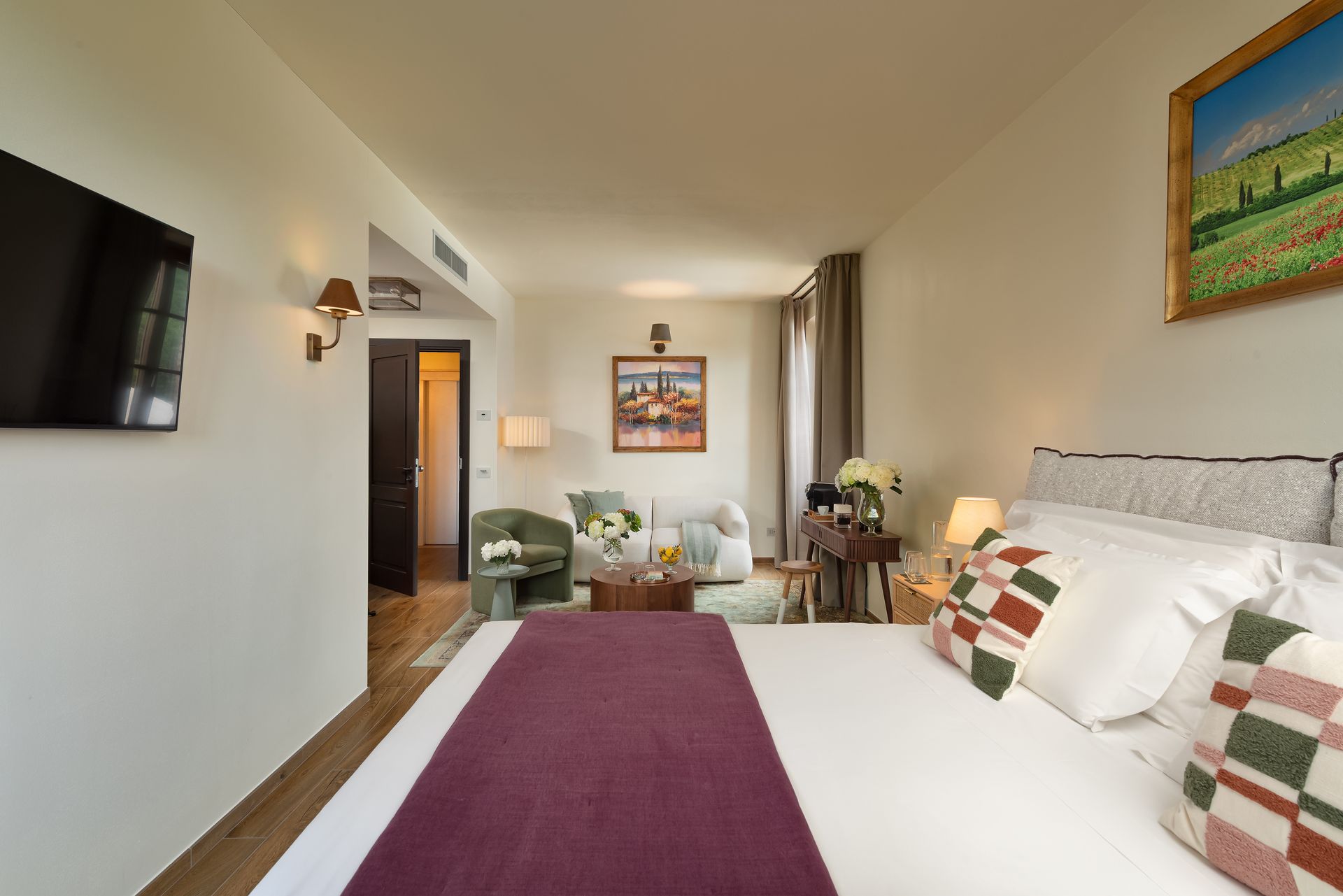 Large hotel room with a king size bed and a flat screen tv.
