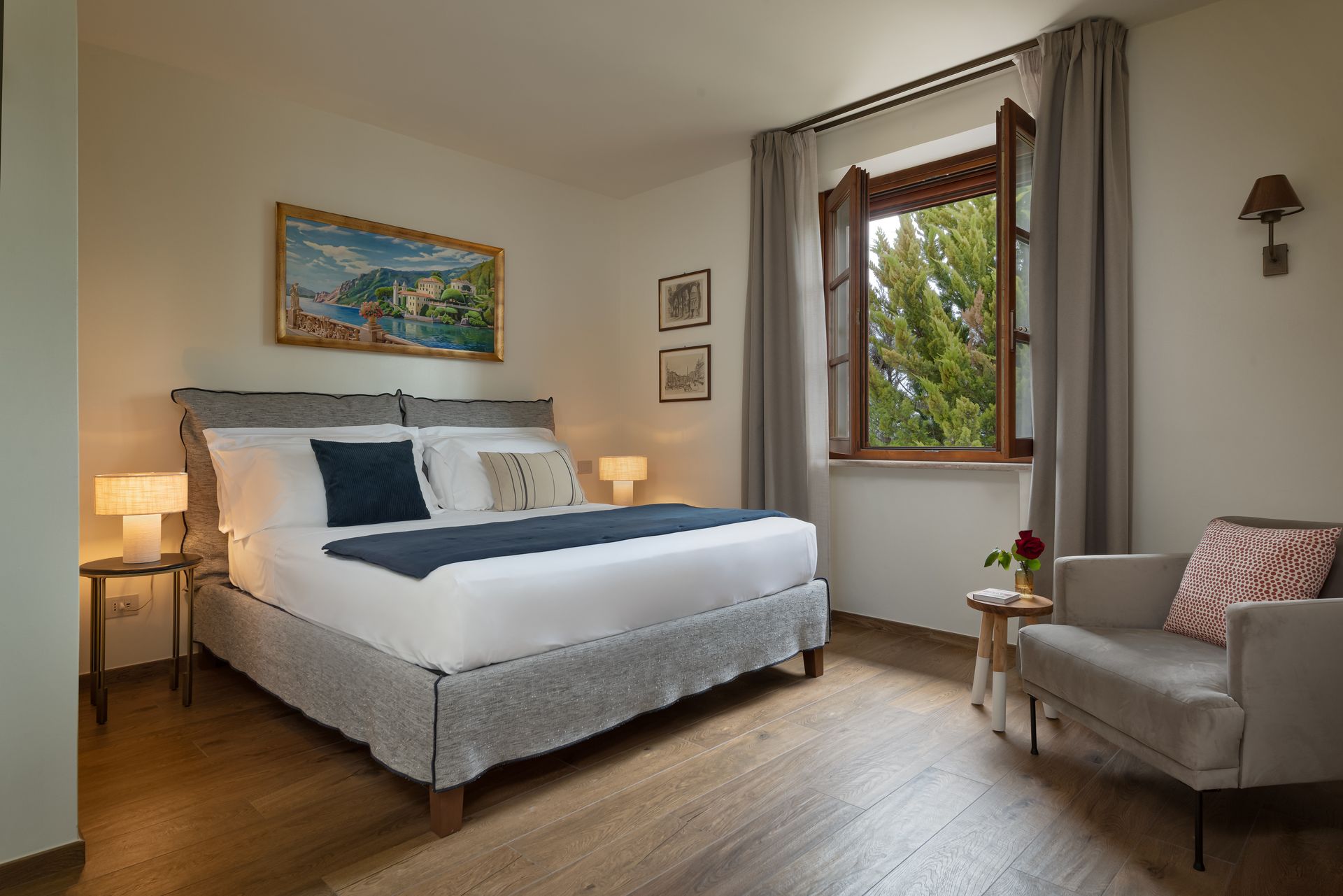 A bedroom with a large bed , chair and window.