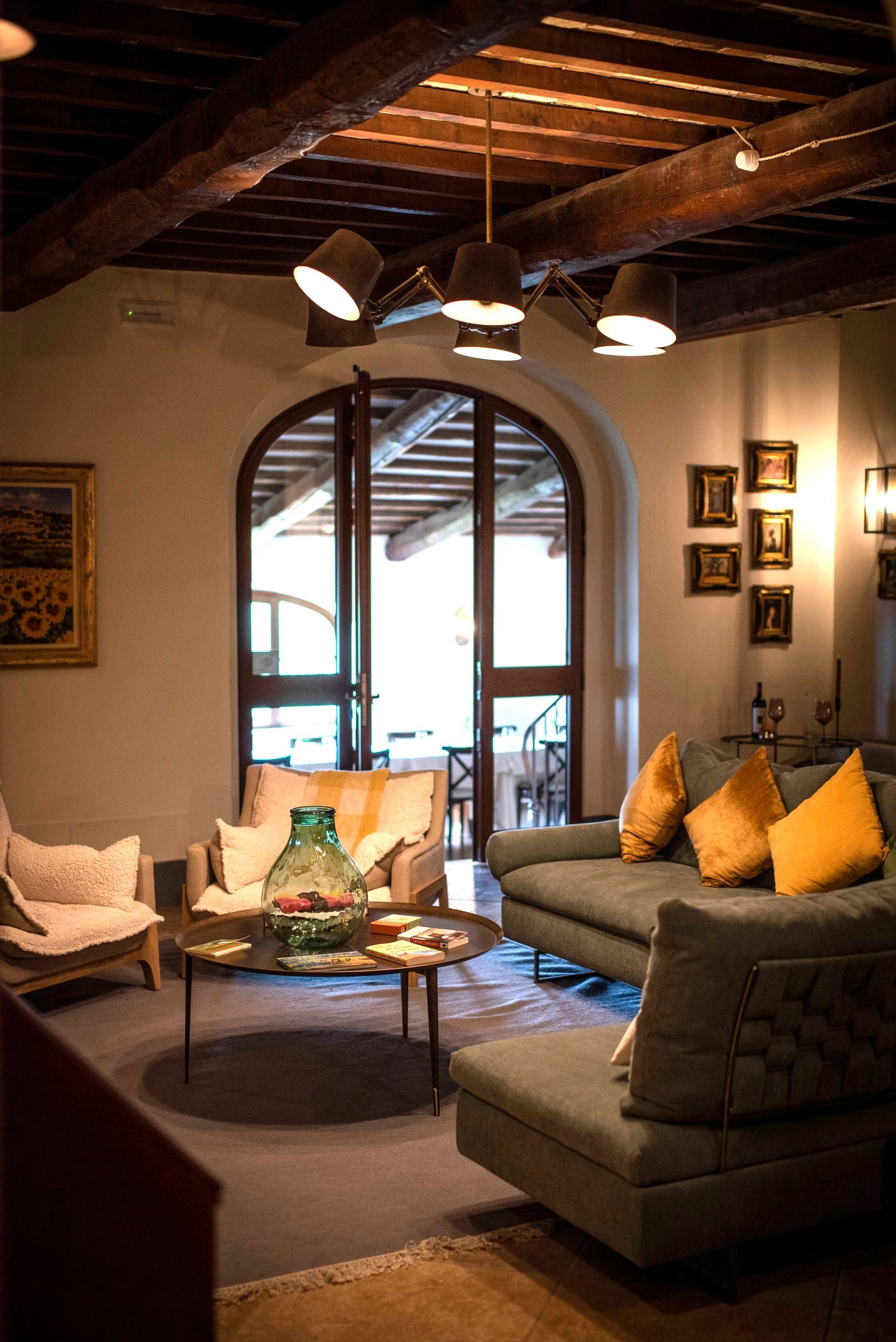 A living room with a couch , chairs , and a table.
