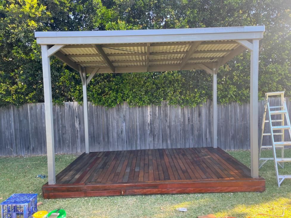 A Wooden Deck Under A Pergola With A Ladder In The Background — Lewis Landscapes In Yippin Creek, NSW