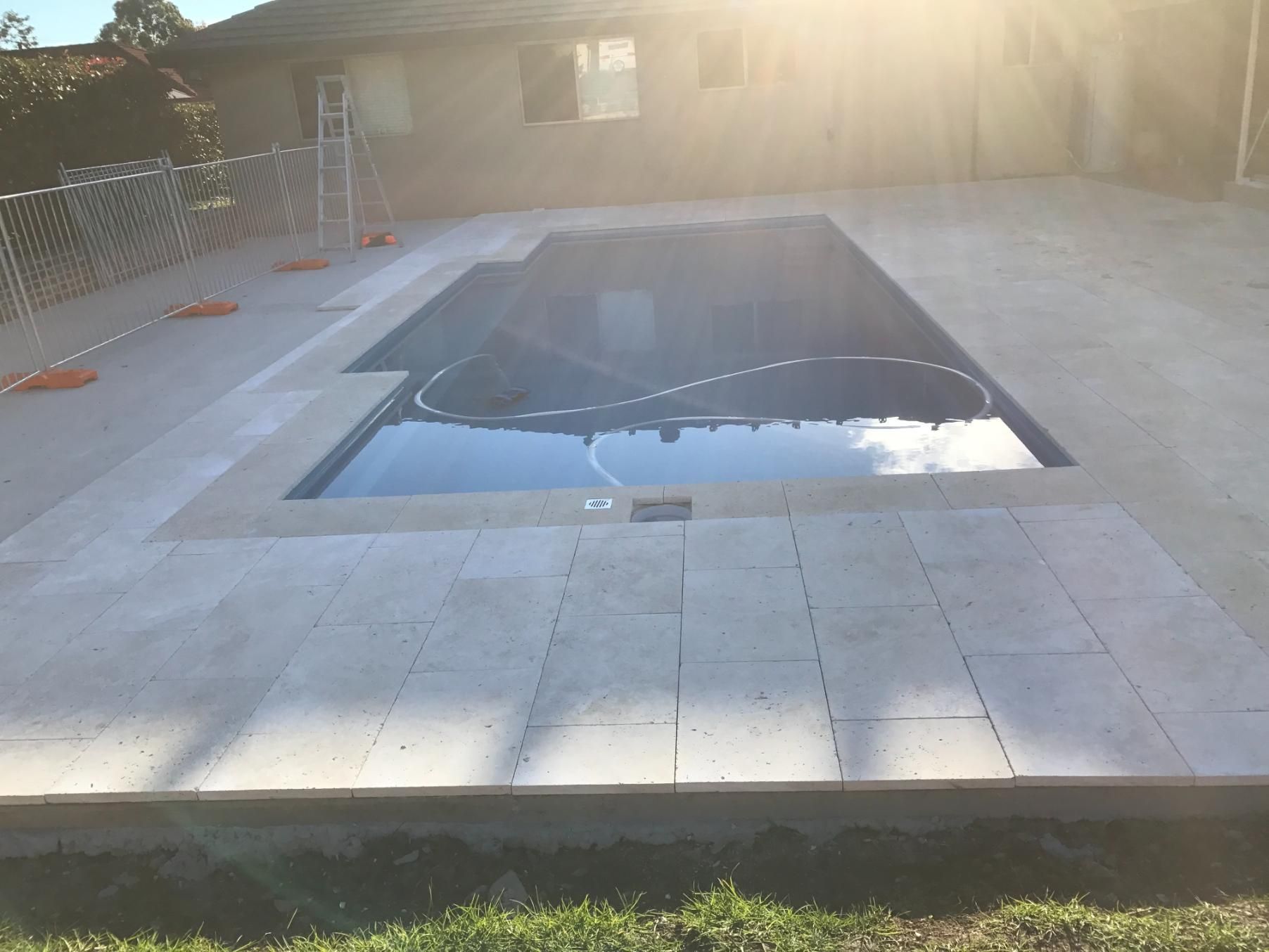 A Large Swimming Pool With A Ladder In The Background — Lewis Landscapes In Yippin Creek, NSW