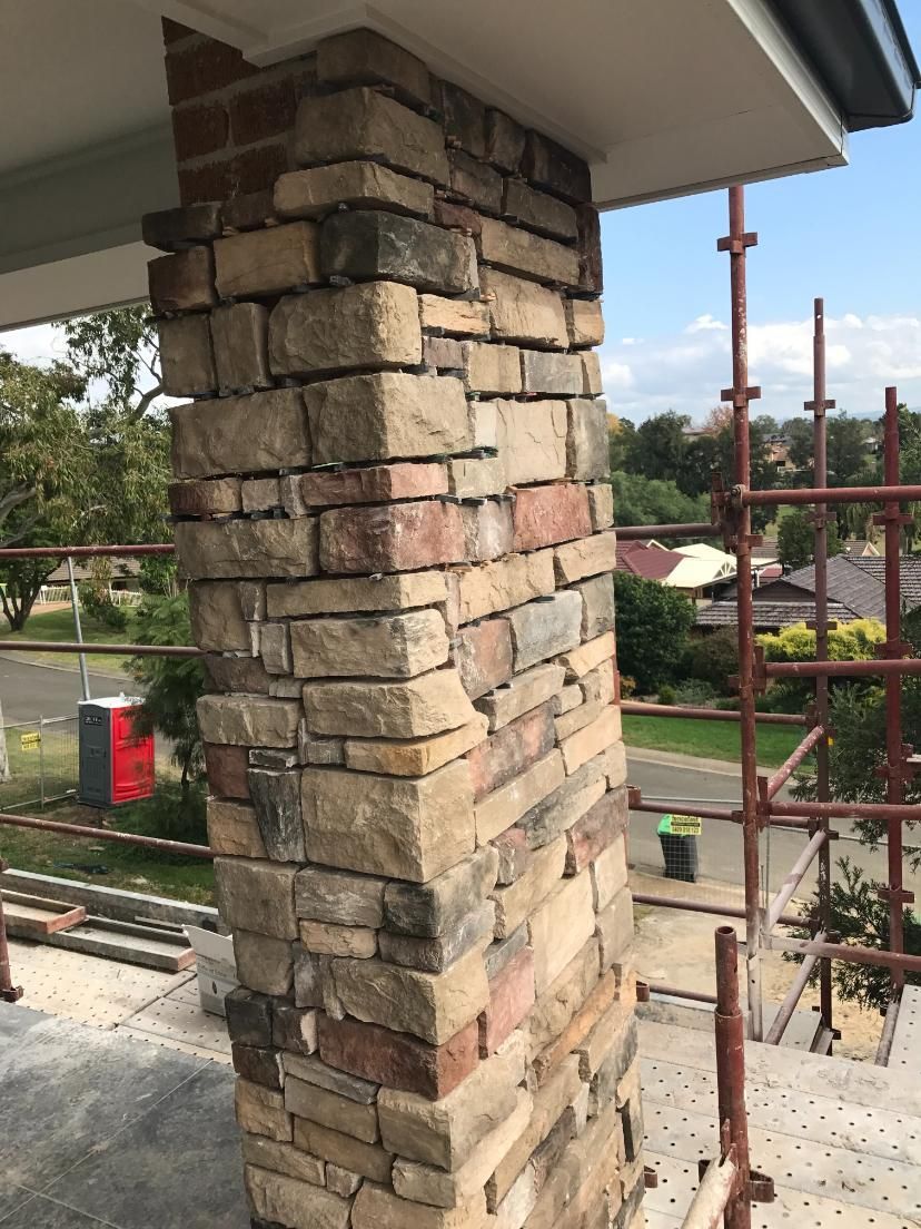 A Brick Chimney Is Being Built On The Side Of A Building — Lewis Landscapes In Yippin Creek, NSW