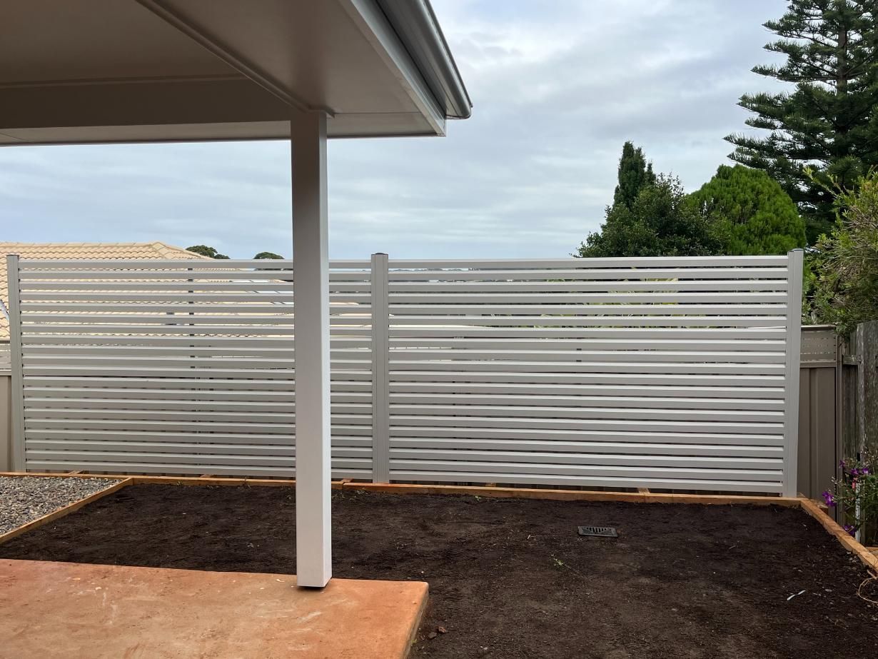 A White Fence Is In The Backyard Of A House — Lewis Landscapes In Yippin Creek, NSW
