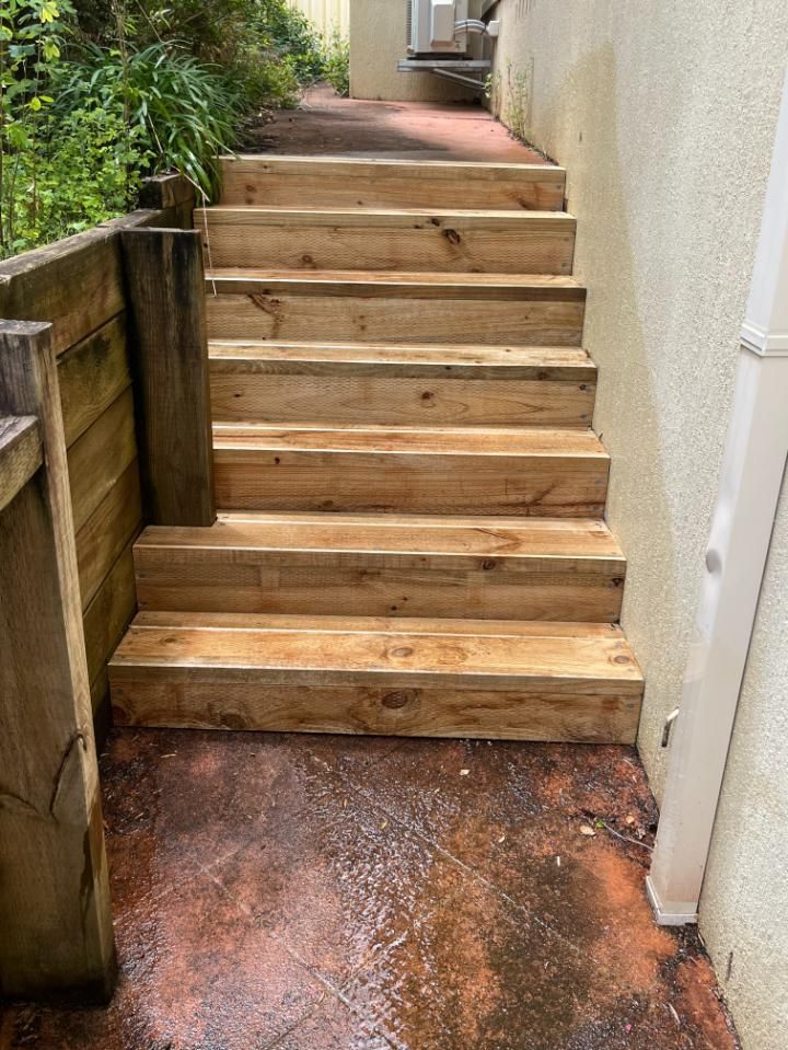 A Set Of Wooden Stairs Leading Up To A House — Lewis Landscapes In Yippin Creek, NSW