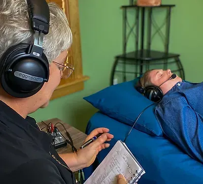 Old Woman Hypnotising Female While Wearing Headphone — Knoxville, IA — Holistic Health & Wellness Center
