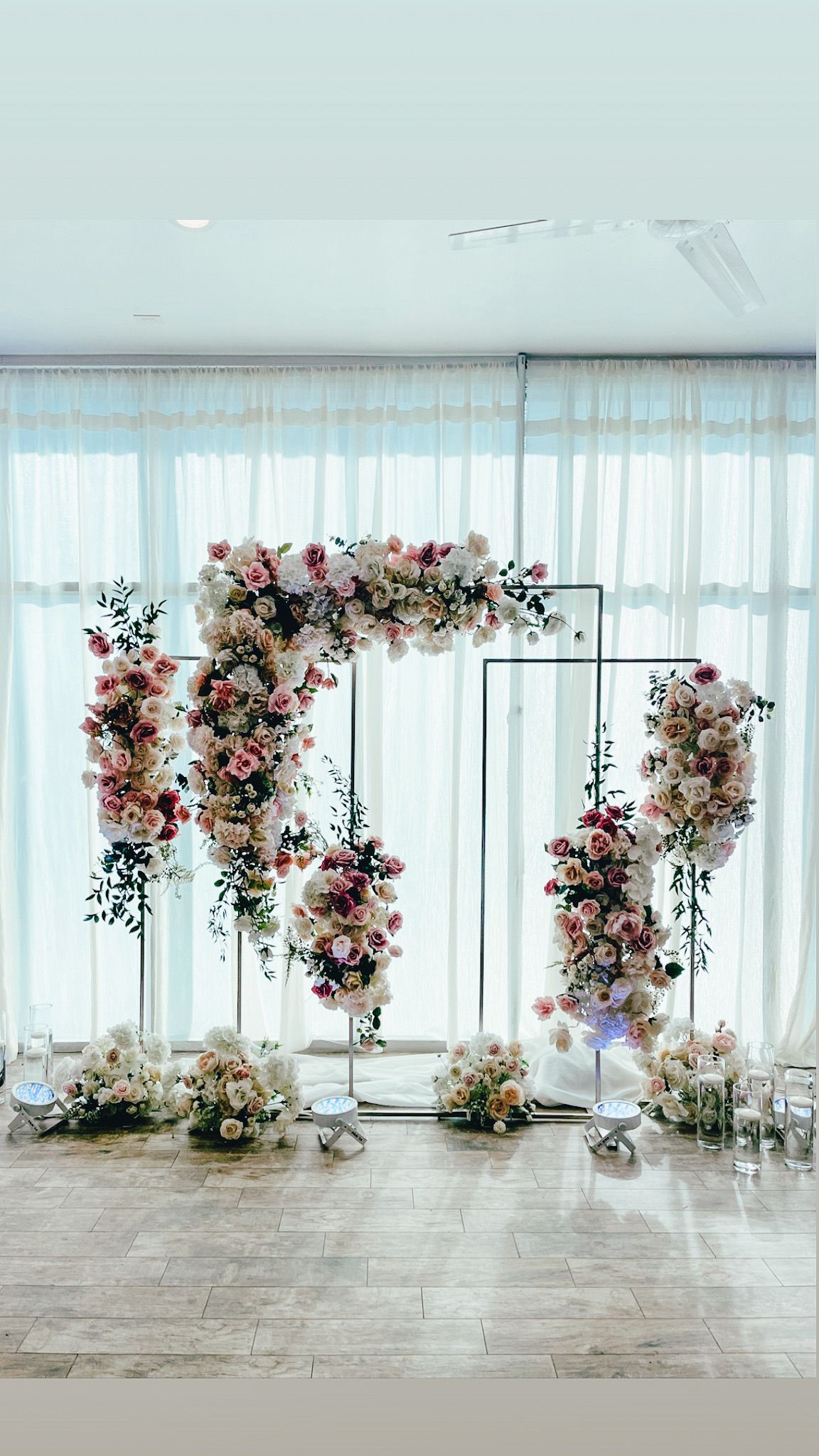 a room filled with lots of flowers and curtains