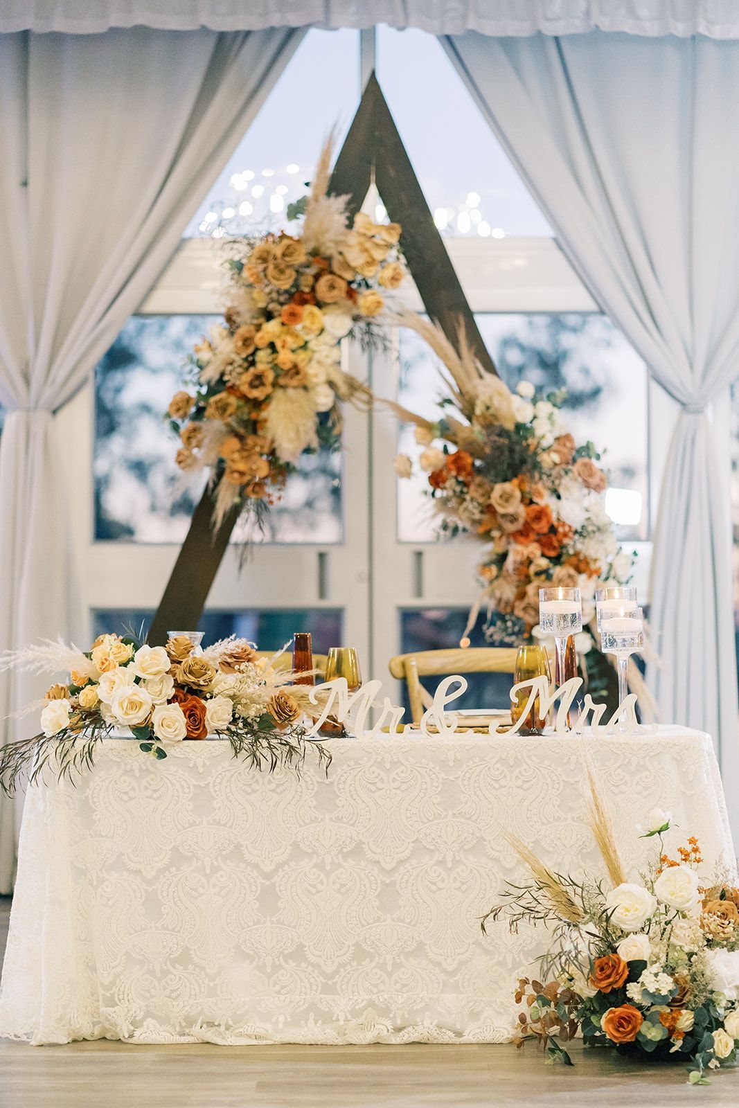 a table with flowers and a sign that says mr. and mrs.