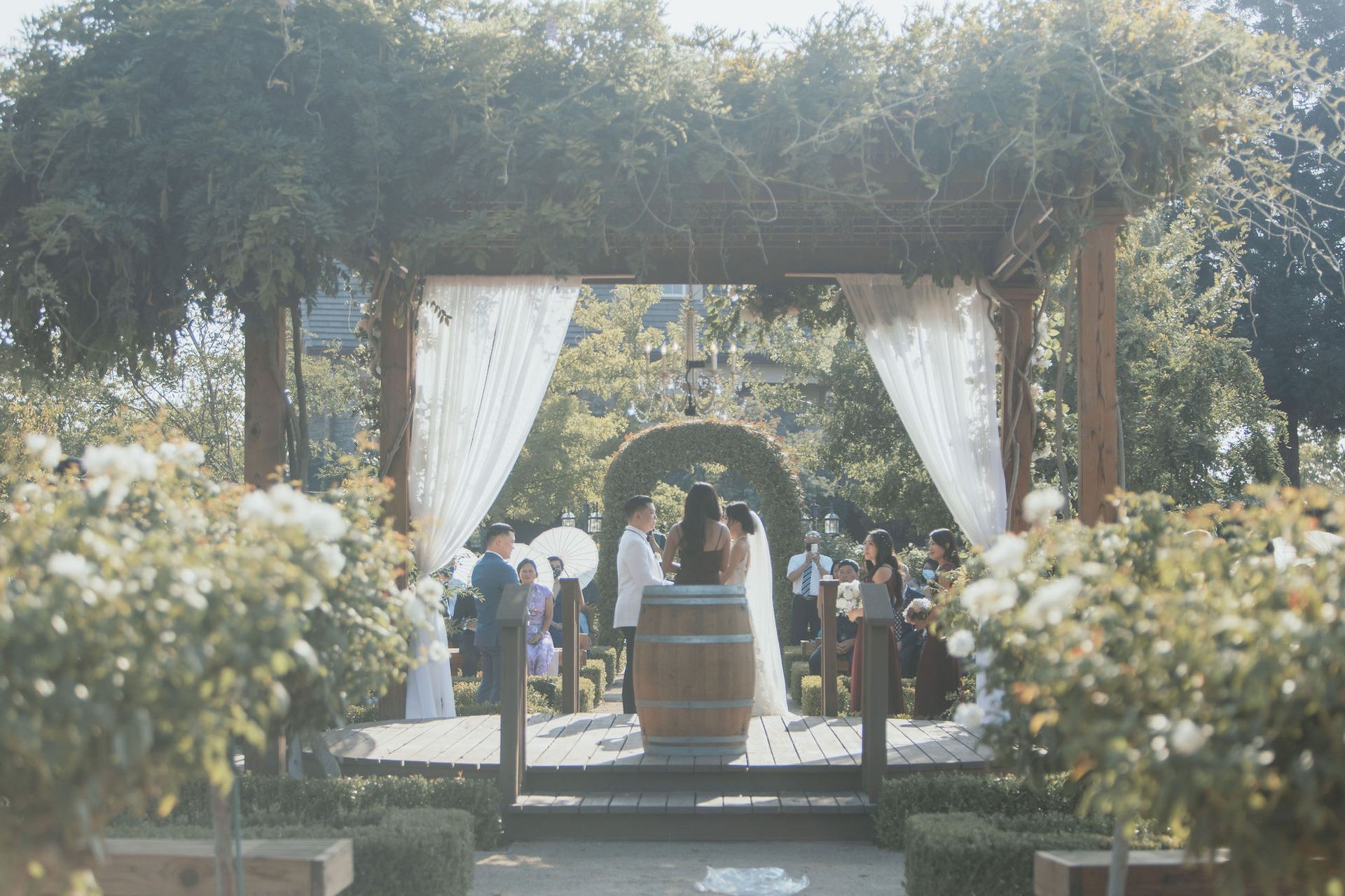 A bride and groom are getting married under a gazebo.