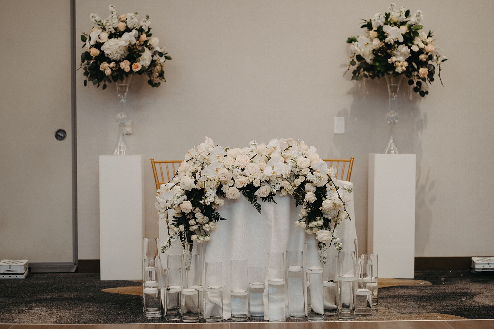 There is a table with flowers and candles on it.