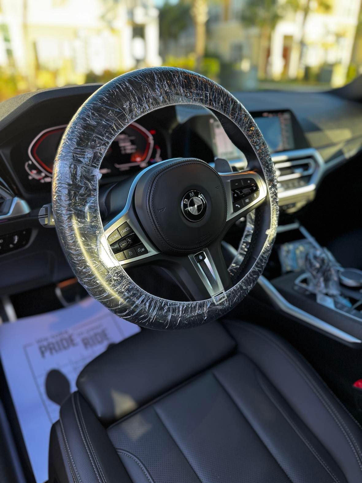 A close up of a steering wheel in a car.