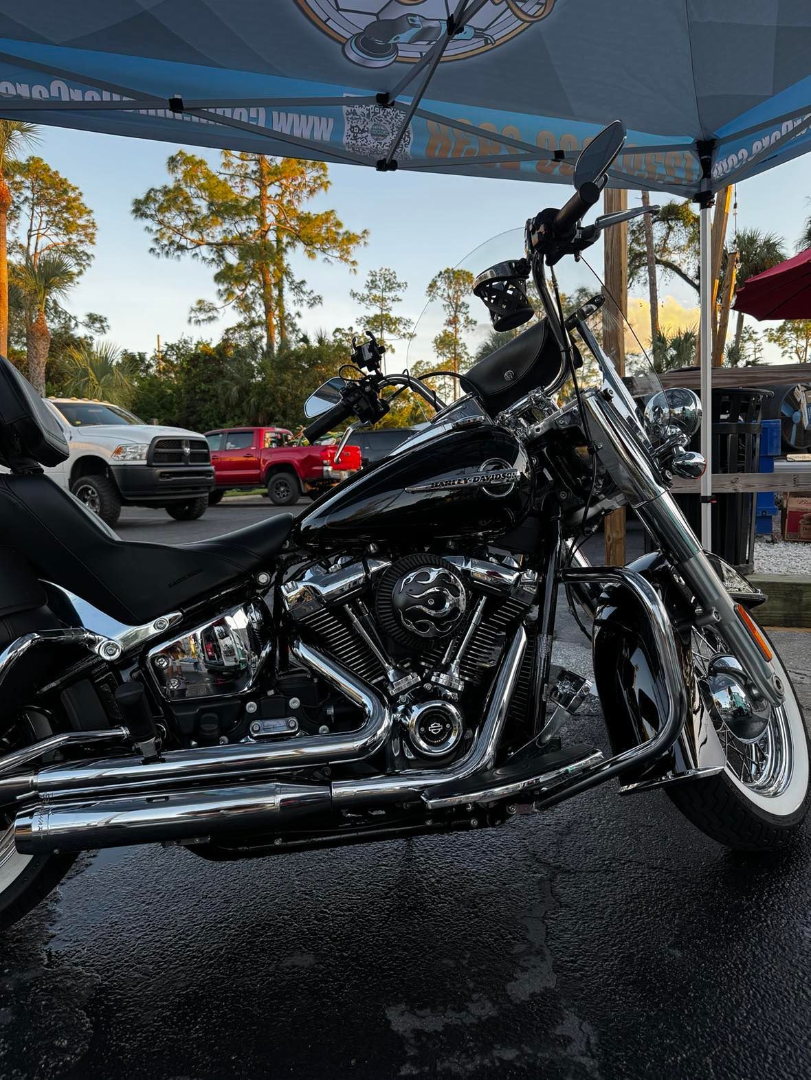 A harley davidson motorcycle is parked in front of a tent.
