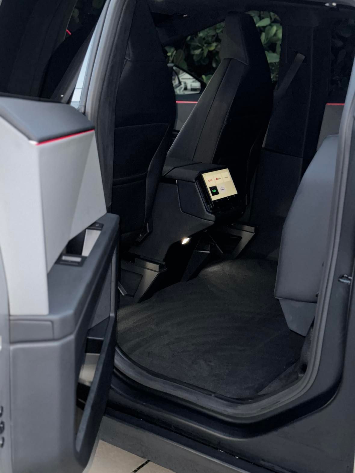 The back seat of a car with the door open
