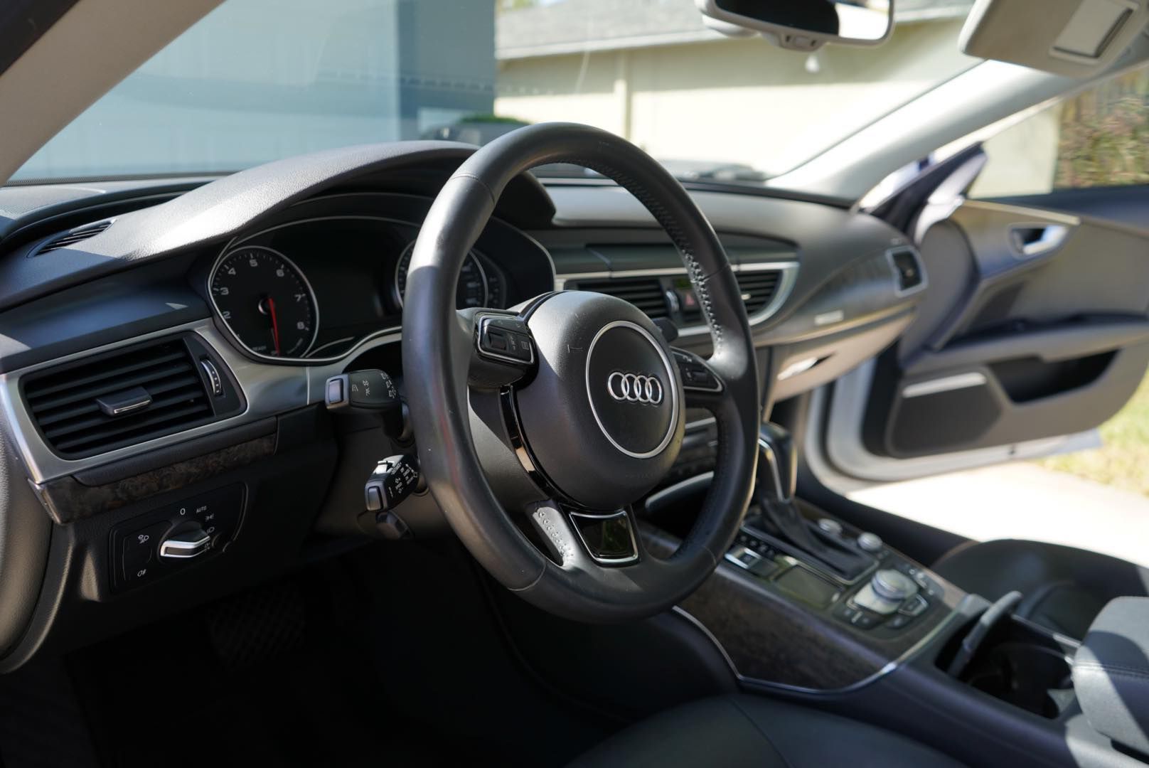 The inside of an audi car with the door open