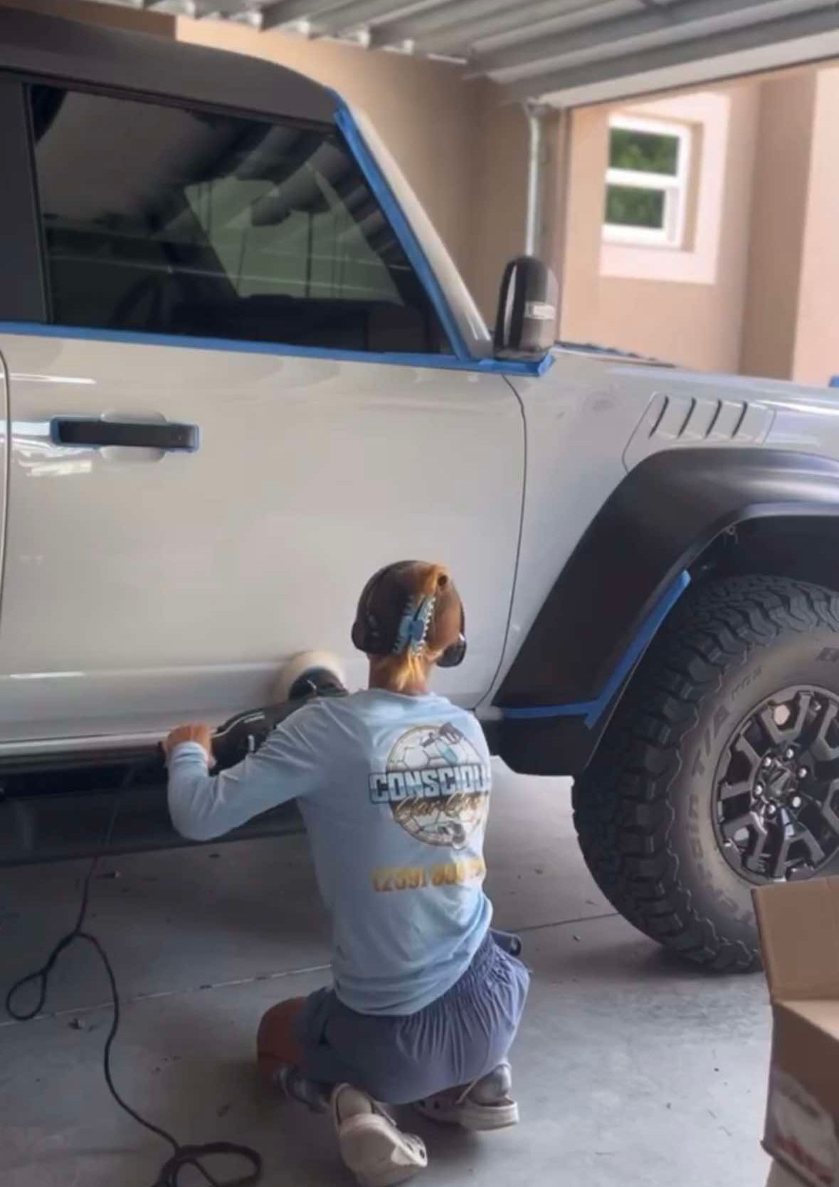 A brown bentley is parked in a garage