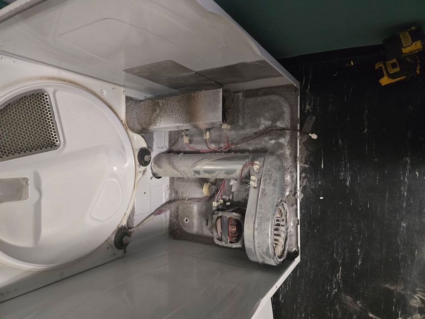 Close-up diagnostic inspection of a home appliance component.