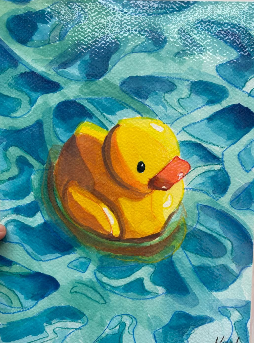 Yellow rubber duck floating in blue watercolor pool.