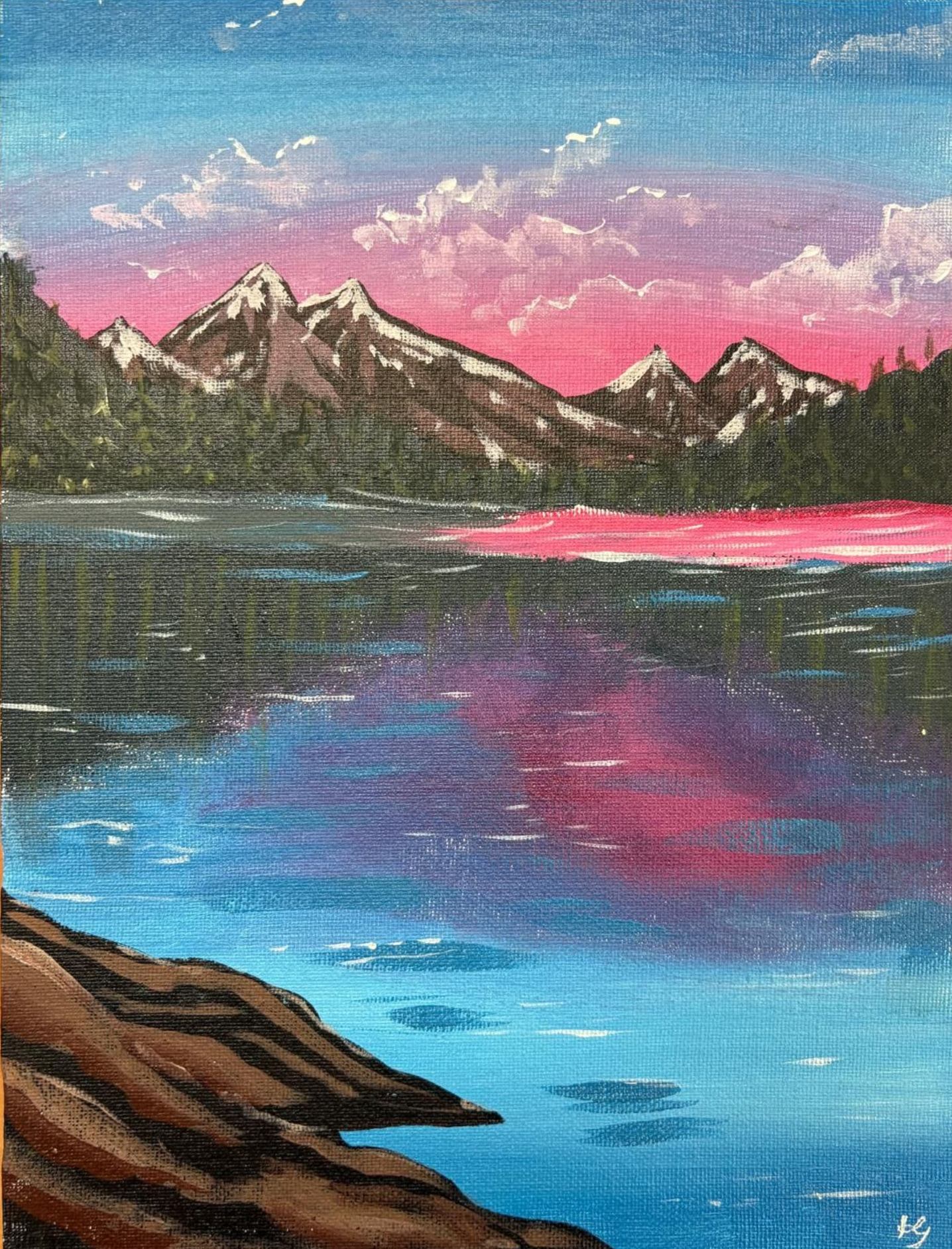 A landscape painting of mountains reflected in a lake at sunset. Pink and purple sky with blue water.