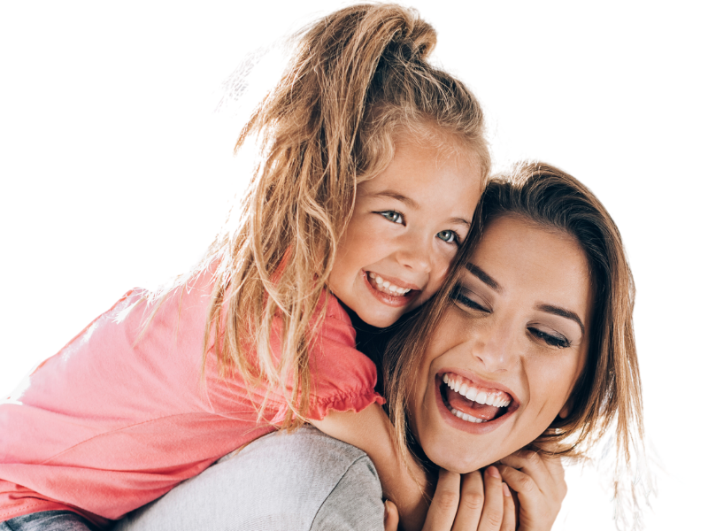 A woman is carrying a little girl on her back.