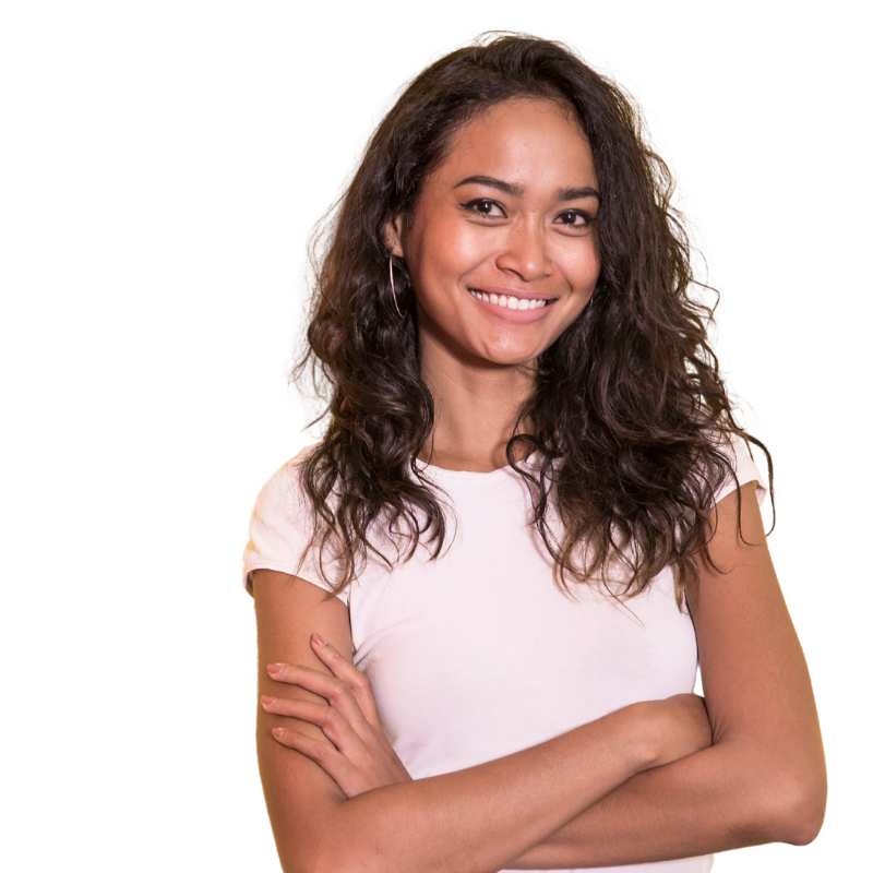 A woman with curly hair is smiling with her arms crossed