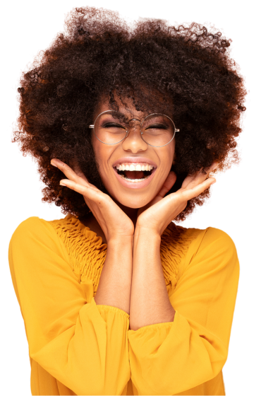 A woman wearing glasses and a yellow shirt is laughing, her hands are highlighting her mouth.